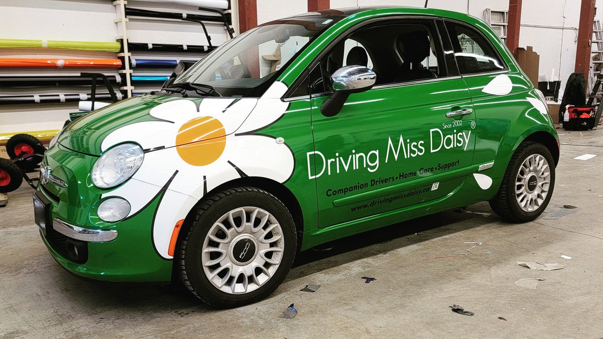 Final inspection of a freshly wrapped vehicle